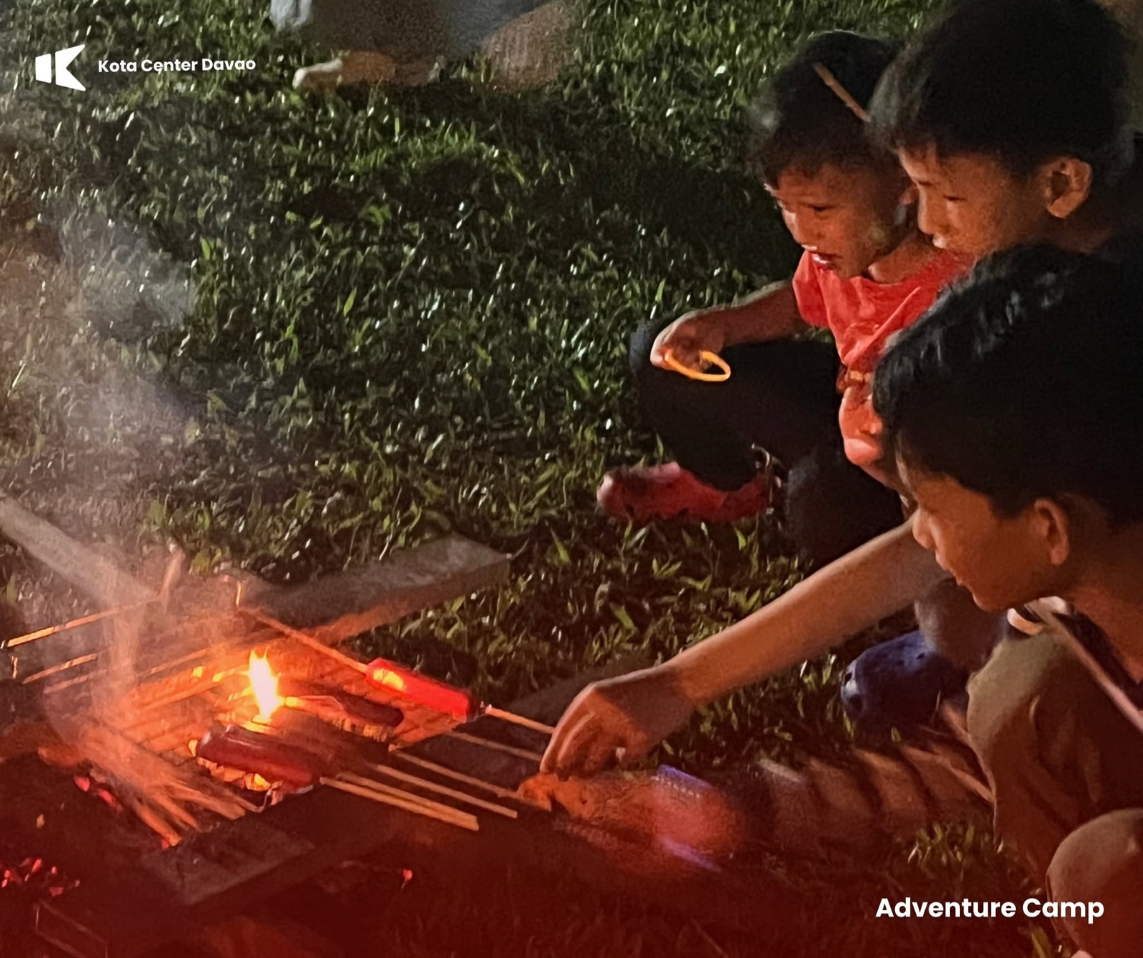 Children gathering around a campfire at KOTA Adventure Camp