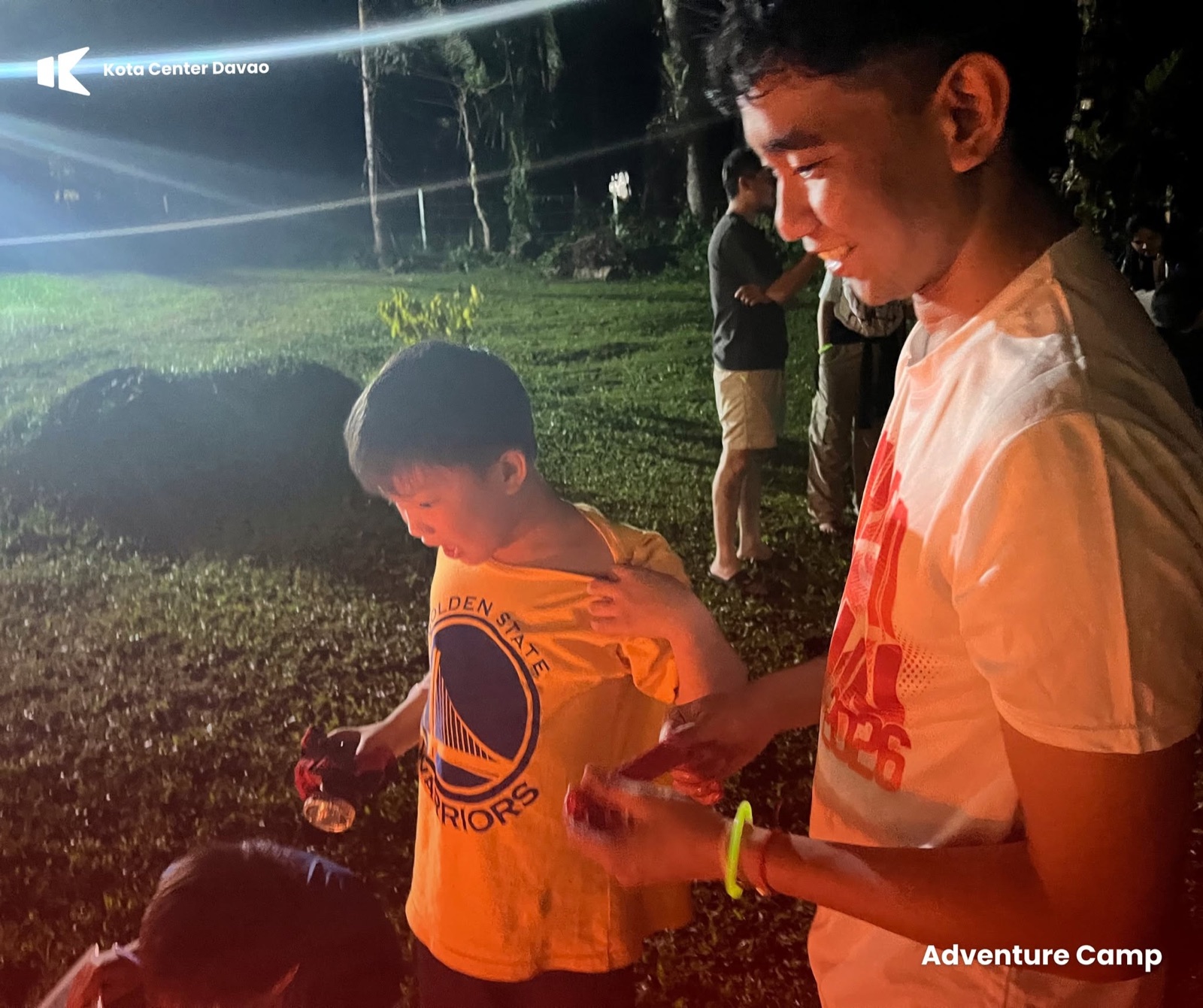 A KOTA mentor helping a child at Adventure Camp