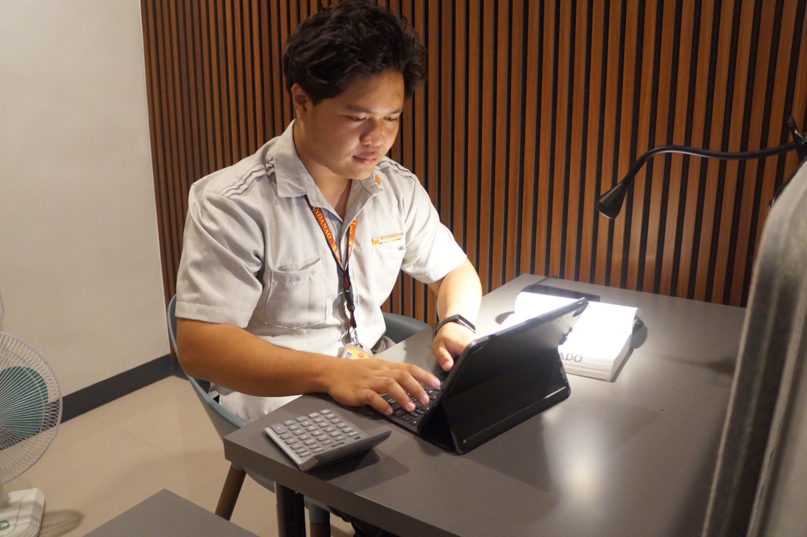 A KOTA student typing on a tablet at a desk