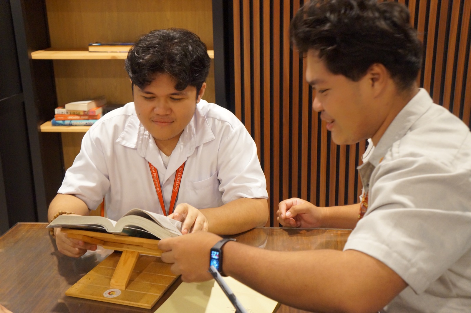 Two KOTA students reading and reviewing a book together