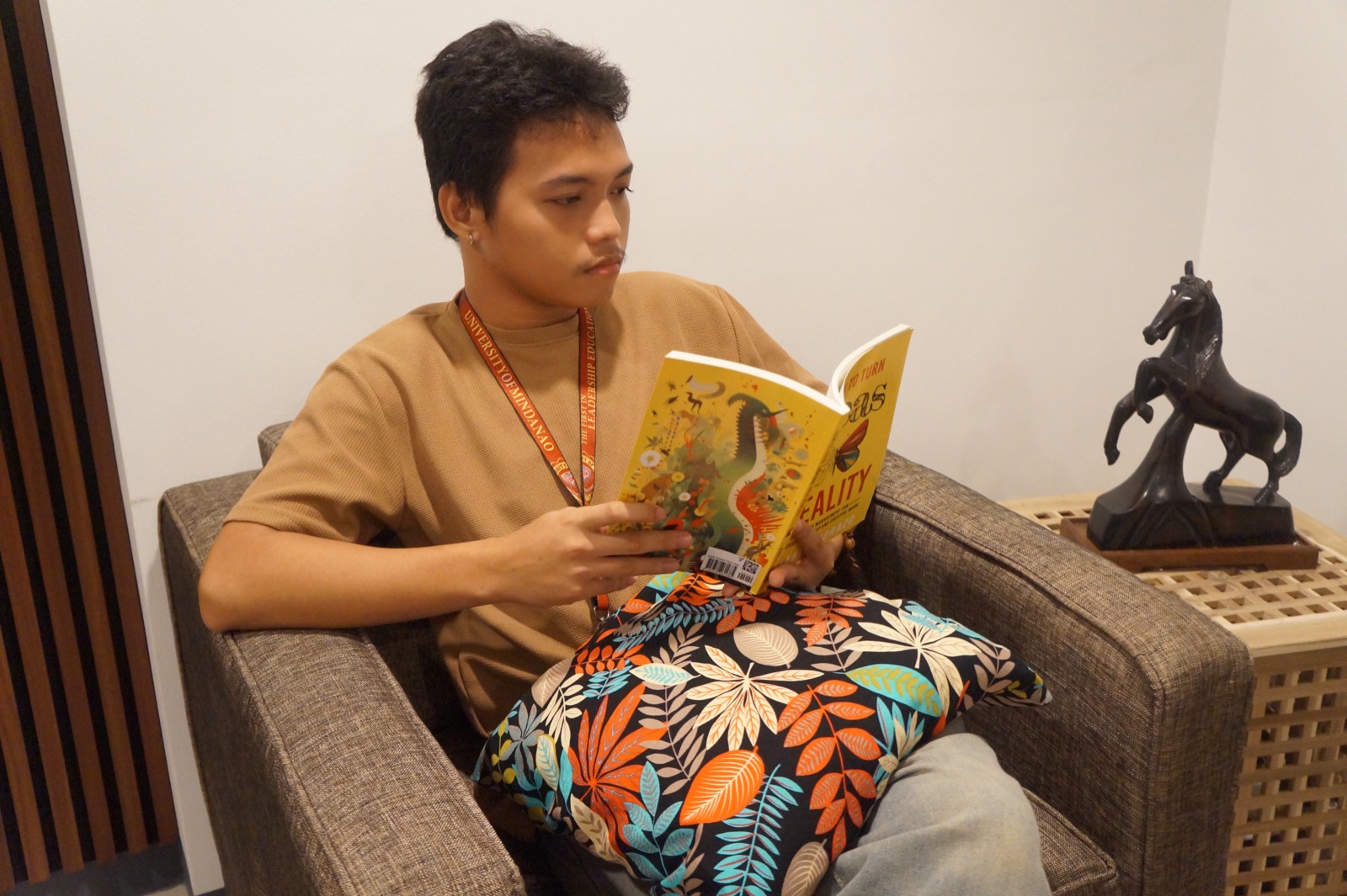 A KOTA student reading solo in a lounge chair